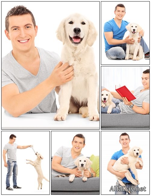 Smiling young man holding a dog - Stock Photo