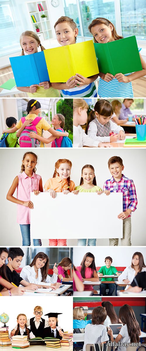 Stock Photo Portrait of confident teenage girl gesturing thumbs up while friends studying in classroom
