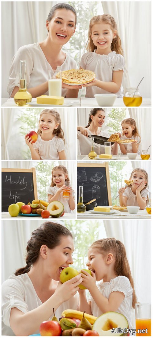 Woman with a little girl, fruit, pancakes - stock photos